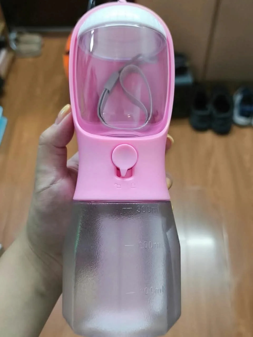 Customer photo of a pink travel bottle indoors