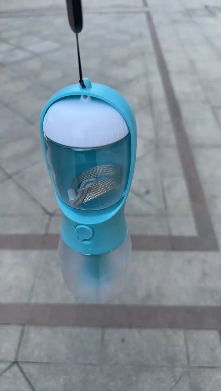 Customer photo of a blue bottle carried by its wrist strap outdoors